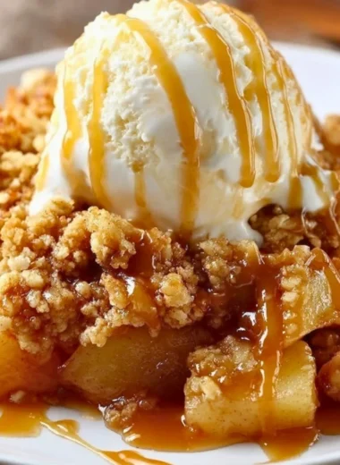 Delicious baked apple crumble served warm with a golden oat topping