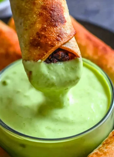 Baked black bean taquitos served with salsa and fresh garnishes