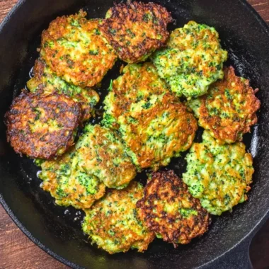 Plate of golden brown broccoli fritters served with dipping sauce