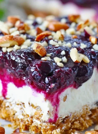 Delicious Blueberry Pretzel Salad with blueberries, cream, and pretzel crust