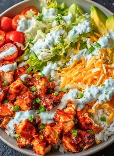 Delicious Buffalo Chicken Bowl topped with fresh ingredients and tangy sauce