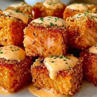Crispy Bang Bang Salmon Bites garnished with sauce and herbs