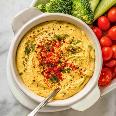 Delicious deviled egg dip served with crackers and vegetables
