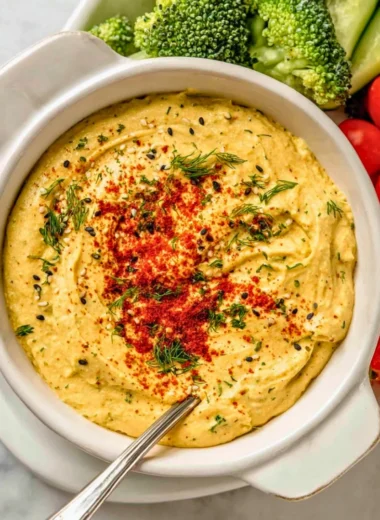 Delicious deviled egg dip served with crackers and vegetables