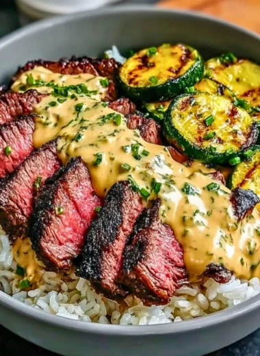 Grilled steak bowl with sauce and grilled zucchini on a plate