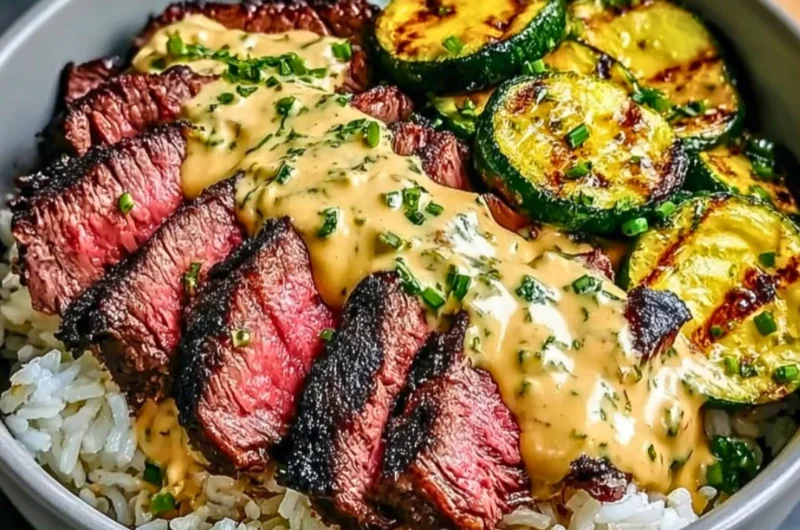 Grilled steak bowl with sauce and grilled zucchini on a plate