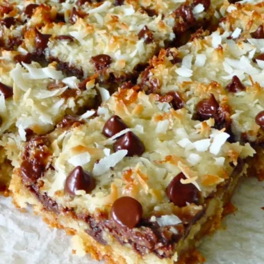 Delicious Magic Cookie Bars with chocolate, coconut, and nuts on a plate.