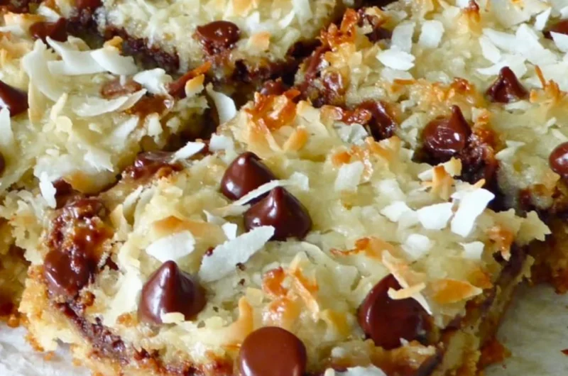 Delicious Magic Cookie Bars with chocolate, coconut, and nuts on a plate.