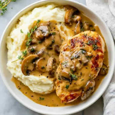 Delicious Mushroom Chicken dish served with creamy sauce and garnished with herbs.