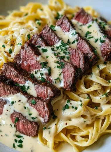Plate of savory Steak Gorgonzola Alfredo with creamy Parmesan sauce