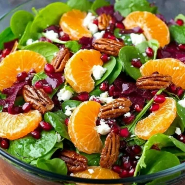 A colorful winter salad featuring seasonal greens, nuts, and fruits.