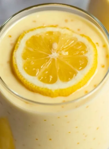 Bowl of delicious lemon cream chia pudding with fresh lemon slices and berries
