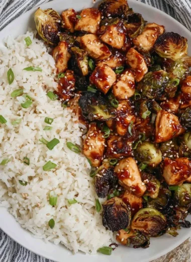 Air fried chicken breast served with Brussels sprouts on a white plate