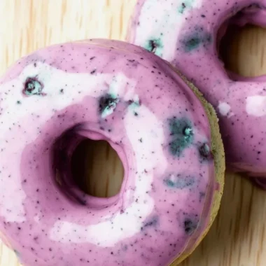 Delicious blueberry cake donuts topped with icing and fresh blueberries.