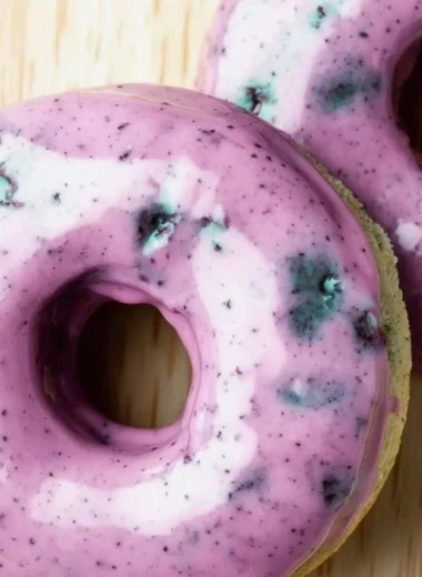 Delicious blueberry cake donuts topped with icing and fresh blueberries.