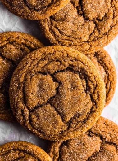 Chewy pumpkin spice molasses cookies on a rustic wooden table