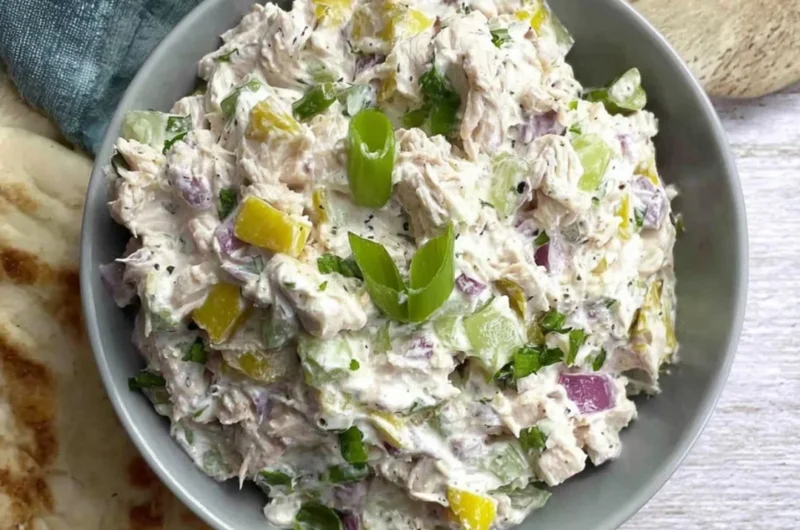 Cottage cheese chicken salad with banana peppers in a bowl garnished with herbs