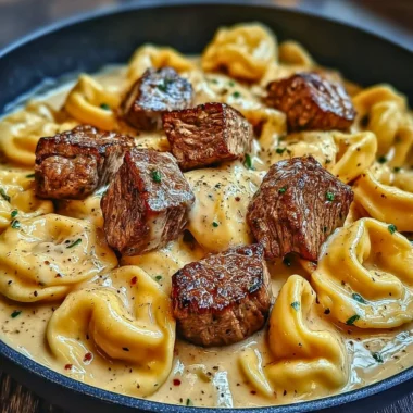 Cracked garlic steak tortellini in creamy sauce served on a plate