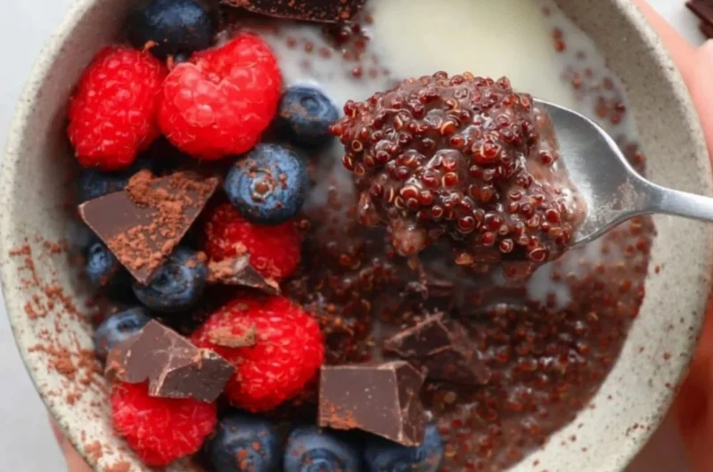 Delicious dark chocolate quinoa breakfast bowl topped with fresh fruits and nuts