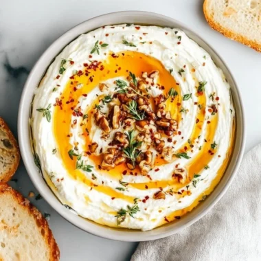 Delicious ricotta dip drizzled with hot honey served in a bowl.