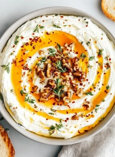 Delicious ricotta dip drizzled with hot honey served in a bowl.