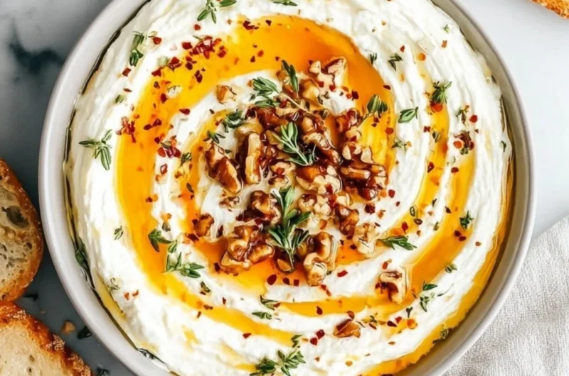 Delicious ricotta dip drizzled with hot honey served in a bowl.