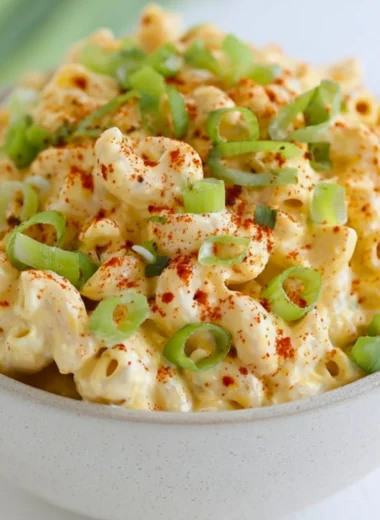 Delicious deviled egg pasta salad served in a bowl with fresh ingredients.