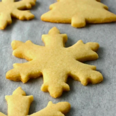 Baking easy sugar cookies on a baking tray with colorful sprinkles