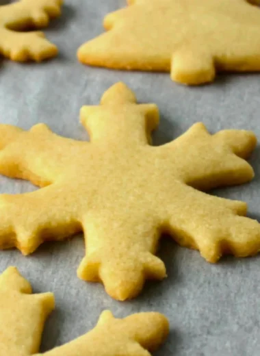 Baking easy sugar cookies on a baking tray with colorful sprinkles