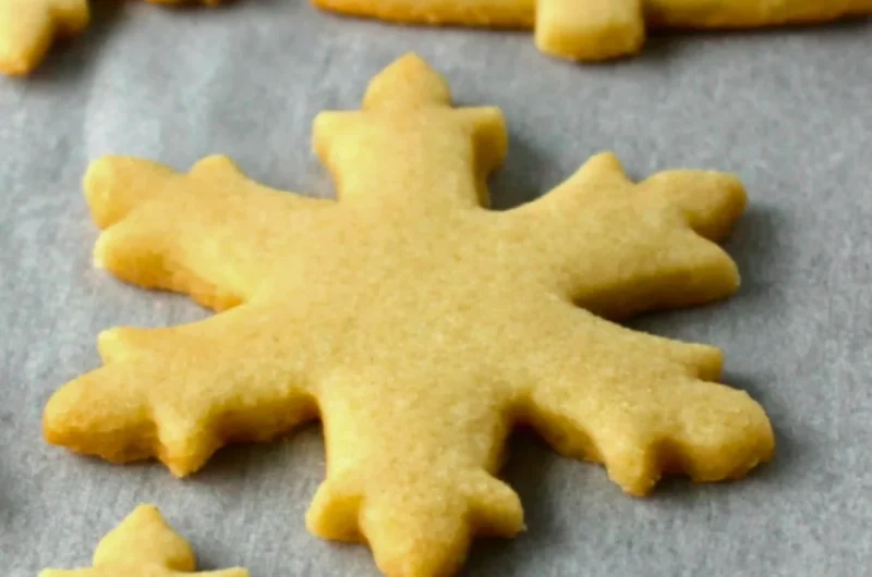 Baking easy sugar cookies on a baking tray with colorful sprinkles