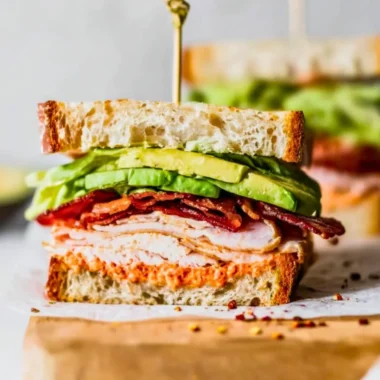 Delicious easy turkey club sandwich stacked with turkey, bacon, lettuce, and tomato.