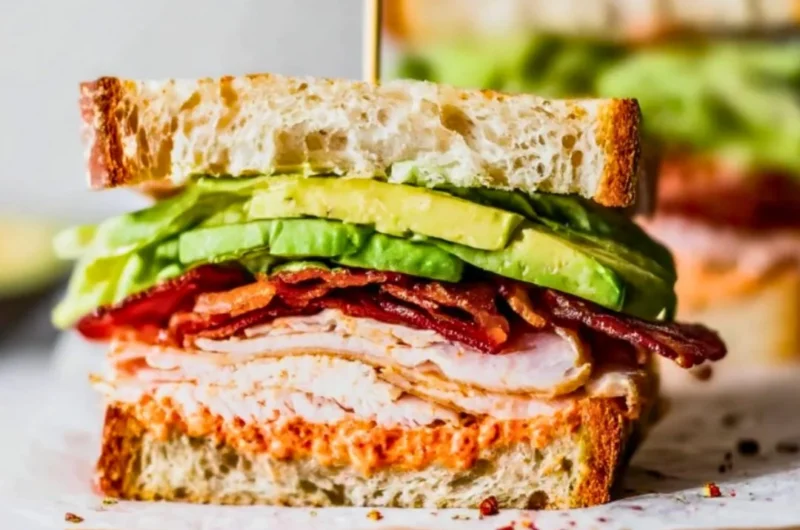 Delicious easy turkey club sandwich stacked with turkey, bacon, lettuce, and tomato.
