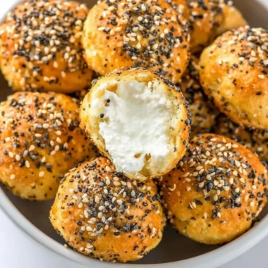 Gluten-free air fryer mini bagels on a plate garnished with herbs