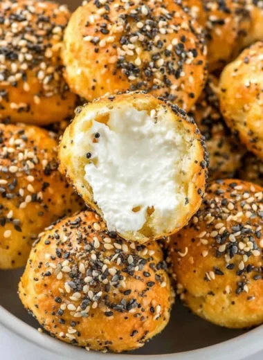 Gluten-free air fryer mini bagels on a plate garnished with herbs