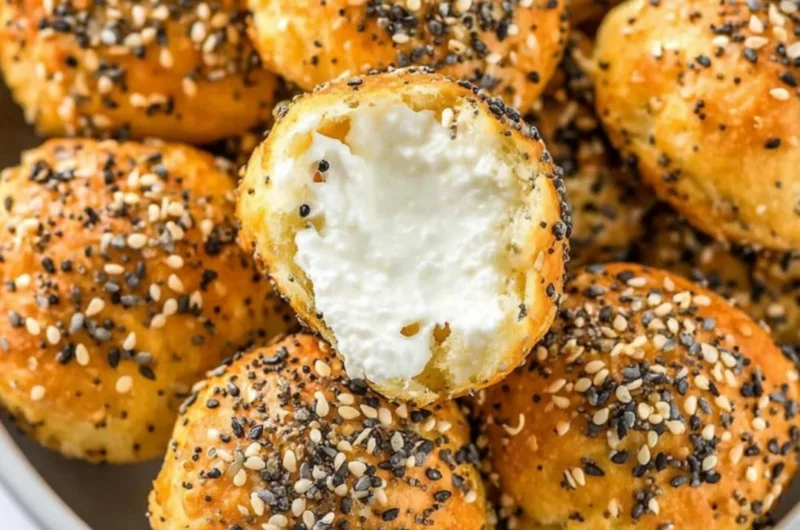 Gluten-free air fryer mini bagels on a plate garnished with herbs