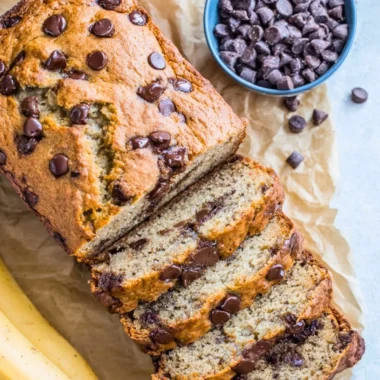 Freshly baked gluten-free banana bread sliced on a wooden board