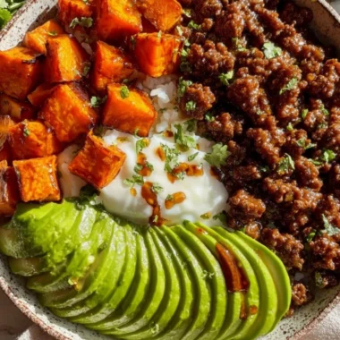 High-protein beef bowl topped with fresh vegetables and rice
