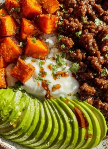 High-protein beef bowl topped with fresh vegetables and rice