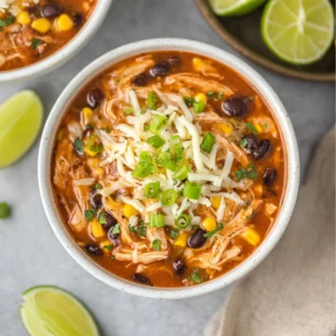 Bowl of high protein chicken taco soup topped with avocado and cilantro