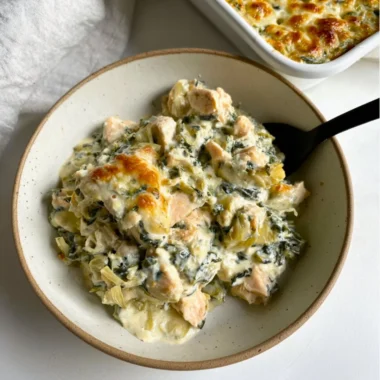High-protein spinach artichoke chicken casserole in a baking dish