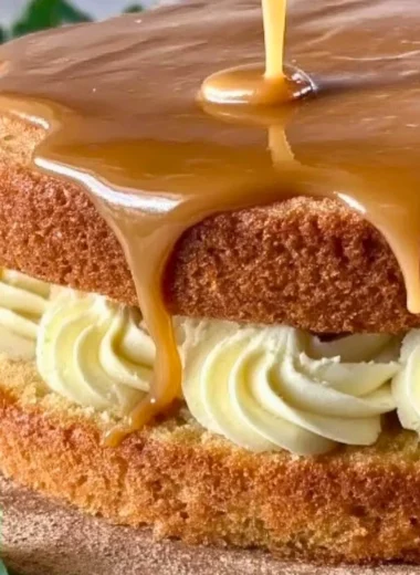 Delicious homemade Irish Whiskey Cake served on a rustic wooden table.