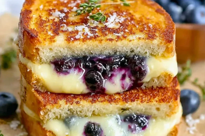 Juicy blueberry grilled cheese sandwich with melted cheese and fresh blueberries