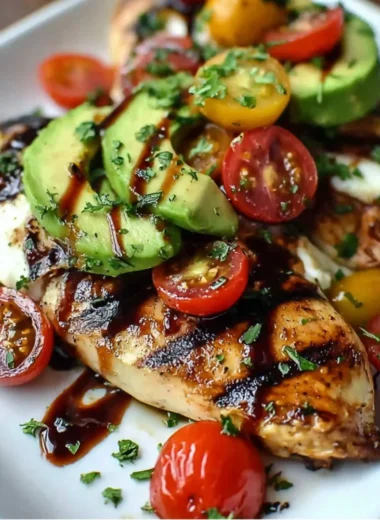 Juicy grilled chicken with California avocado slices on a plate.