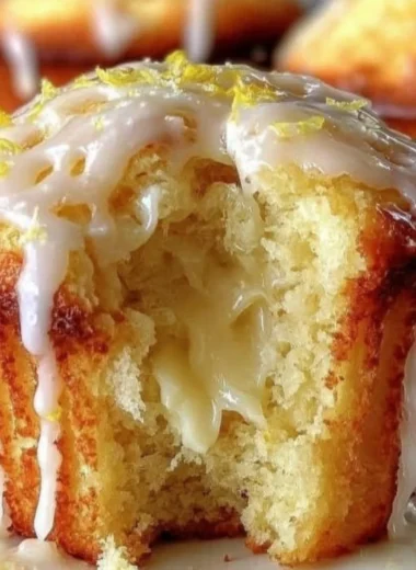 Freshly baked lemon cream cheese muffins on a cooling rack