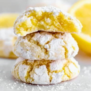 Freshly baked Lemon Crinkle Cookies dusted with powdered sugar