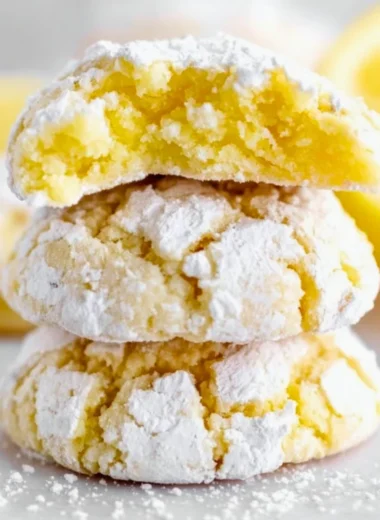 Freshly baked Lemon Crinkle Cookies dusted with powdered sugar