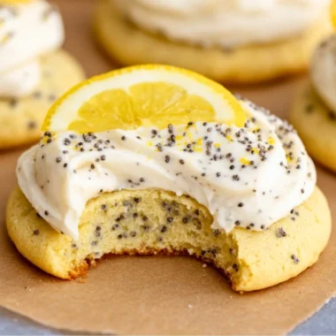 Lemon poppy seed cookies decorated with creamy cheesecake frosting.
