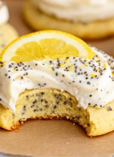 Lemon poppy seed cookies decorated with creamy cheesecake frosting.