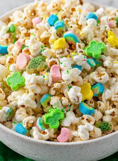 Loaded St. Patrick's Day popcorn topped with green sprinkles and festive treats