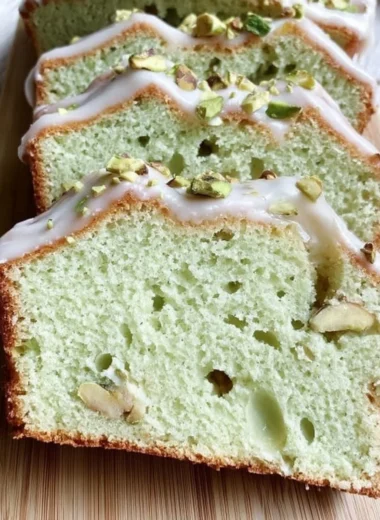 Homemade pistachio pudding bread with a garnish of crushed pistachios